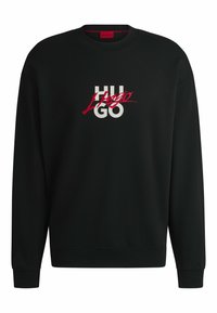 Felpa nera con maniche lunghe, caratterizzata da un audace logo "HUGO" bianco e rosso sul petto, realizzata in morbido tessuto testurizzato.