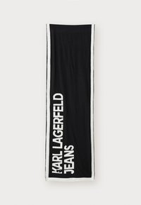 Fekete törölköző fehér szegéllyel, amelyen a "KARL LAGERFELD JEANS" felirat áll vastag betűkkel. Puha, nedvszívó anyagból készült, texturált felülettel.