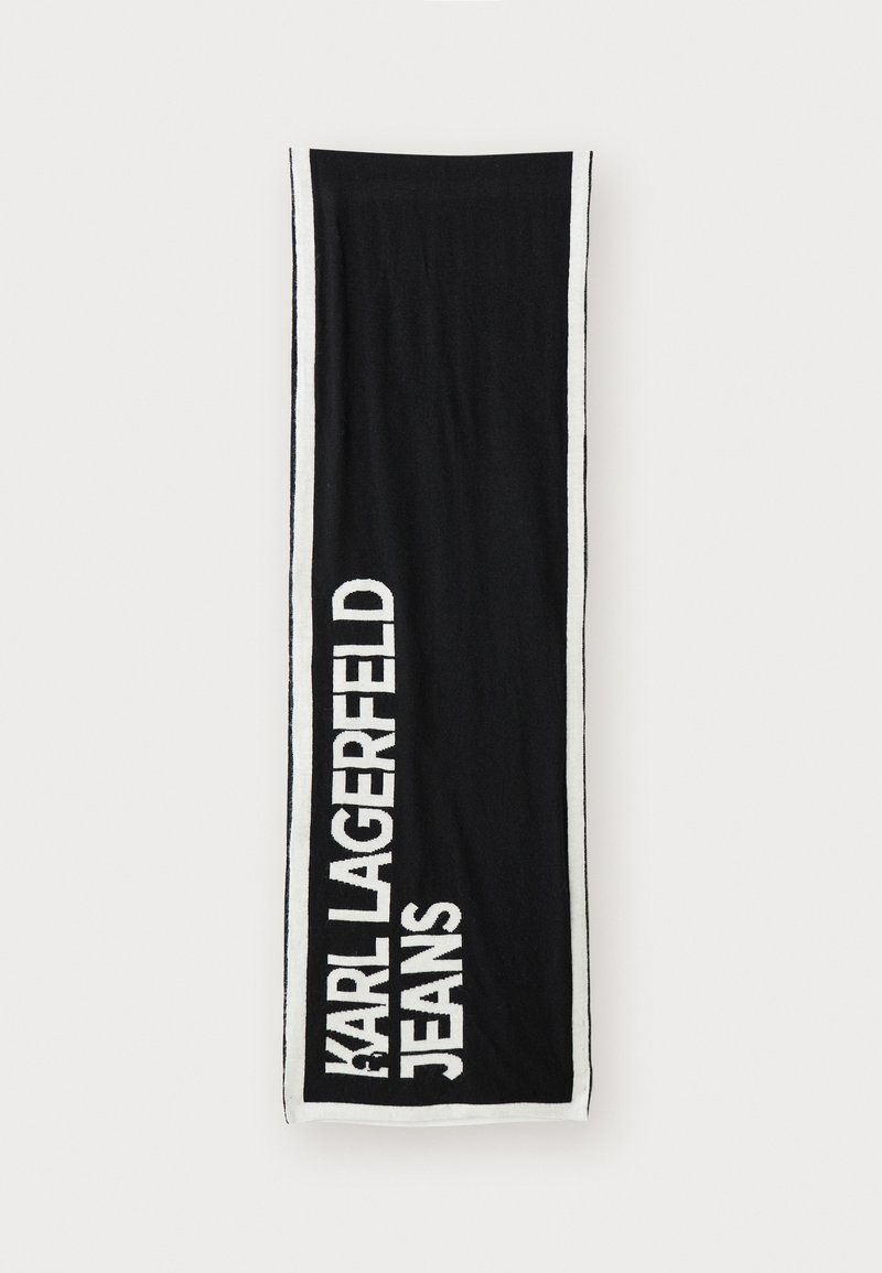 Fekete törölköző fehér szegéllyel, amelyen a "KARL LAGERFELD JEANS" felirat áll vastag betűkkel. Puha, nedvszívó anyagból készült, texturált felülettel.