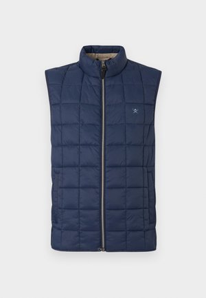 Chaleco sin mangas de color azul marino con un diseño acolchado, cuello alto, cremallera frontal y un discreto bordado del logo en el pecho.