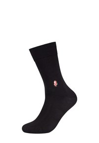 Schwarze Baumwollsocke mit geripptem Bündchen, ausgestattet mit einem kleinen rot-weißen gestickten Charakter an der Seite. Glatte Textur und Standardlänge.