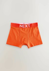Boxer-briefs pour hommes orange avec une ceinture élastique rouge portant le texte "NEXT" en blanc. Le matériau est lisse et extensible.