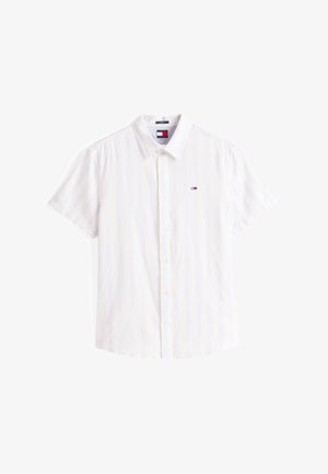 Rövid ujjú gombos ing világos fehér szövetből, finom függőleges csíkozással. A mellzseben kis logó található. Klasszikus gallér kialakítás.