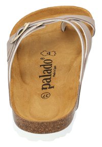 Palado sandals with cork sole, tan suede footbed, and light beige leather straps. Features a decorative metal buckle detailing.