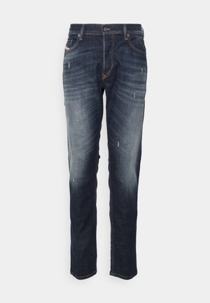 Dark blue denim jeans with slight fading, whiskering, and distressed details. Classic five-pocket design with a button closure.