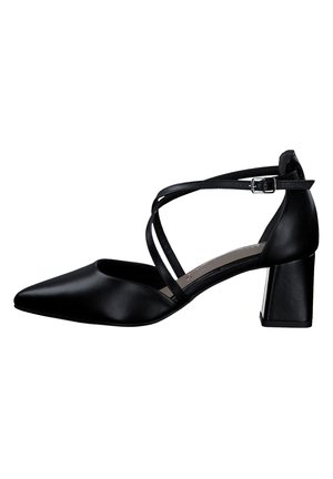 Black leather high-heeled shoe with a pointed toe, ankle strap, and block heel. Features crisscrossing straps for added detail.