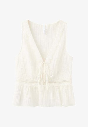 Camicia bianca senza maniche con scollo a V, rifinitura in pizzo lungo lo scollo e la vita, chiusura con laccetto sul davanti e orlo arricciato.
