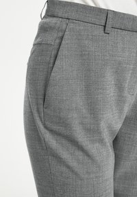 Grå skräddarsydda byxor med vävd textur, sidofickor och platt frontdesign, med rak skärning som faller till vristen.