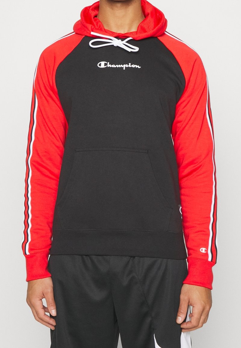 Felpa nera e rossa con tasca frontale, maniche raglan e accenti a strisce bianche, con il logo "Champion" sul petto.