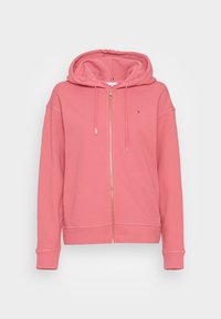 Růžová mikina na zip s kapucí na šňůrku, dlouhými rukávy a malým logem na levé části hrudi, zobrazená na bílém pozadí.