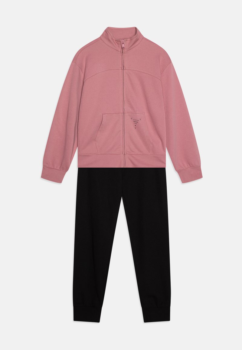 Pink zip-up jacket with a high collar and front pocket, paired with black jogger pants. Soft fabric, casual design, elastic cuffs.