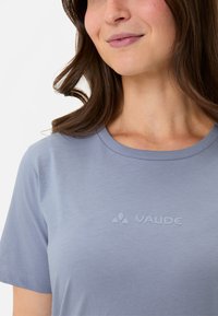 Light blue short-sleeve t-shirt with a crew neck and a subtle VAUDE logo printed on the front. Smooth fabric, simple design.