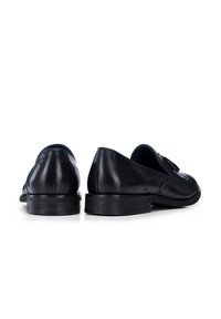 Black leather shoes with a smooth finish, slight heel, and decorative stitching along the sides. Rounded toe design.
