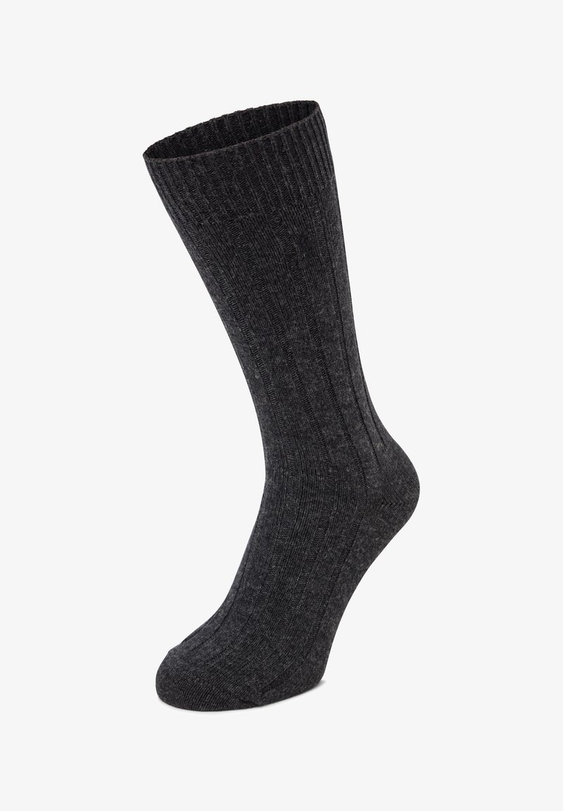 Calza grigia scuro a costine con una forma lunga e affusolata. Realizzata in tessuto strutturato, presenta linee verticali lungo il corpo per un dettaglio aggiuntivo.