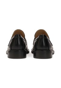 Black leather shoes with a smooth finish, rounded toe, low heel, and no laces. Features stitching detail along the edges.