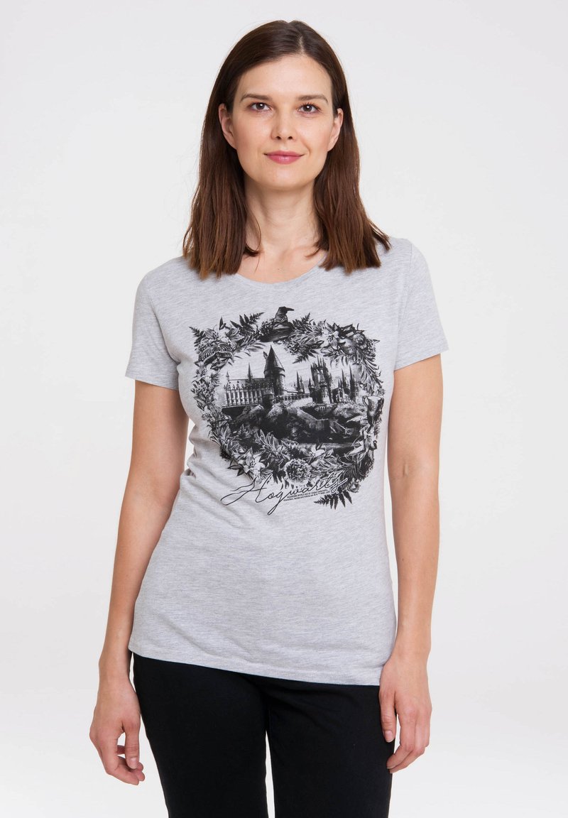 Gray short-sleeve T-shirt features a black print of Hogwarts amid floral accents and the word "Hogwarts" in cursive at the bottom.