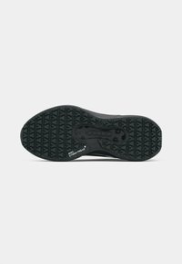 Czarna podeszwa sportowa z teksturowanym wzorem zapewniającym grip, z logo "NIKE STORM-TREAD" oraz zaokrąglonym przodem.