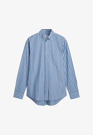 Langärmliges Hemd mit Knopfleiste in blau-weißen vertikalen Streifen, mit einer einzelnen Brusttasche und einem abgerundeten Saum. Aus Baumwolle.