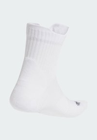 White athletic sock with ribbed texture, low-cut design, and reinforced heel. Features a small logo near the toe area.