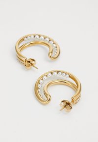 Gold hoop earrings featuring a curved design, adorned with white pearls and tiny rhinestones, showcasing a polished metallic finish.