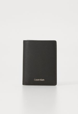 Portafoglio in pelle nera con finitura testurizzata, design pieghevole a due scomparti, caratterizzato da un logo dorato sulla parte anteriore inferiore. Aspetto minimalista e elegante.