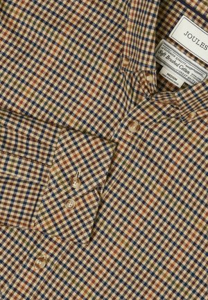 Brushed cotton shirt featuring a plaid pattern in brown, blue, green, and orange. Includes buttoned collar and cuffs with beige buttons.