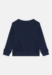 Sweatshirt bleu marine à manches longues, col rond, et avec des poignets et un ourlet côtelés. Fabriqué en matériau doux, avec un design uni.