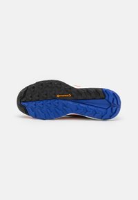 Black and blue rubber shoe sole with a textured surface, featuring a Continental logo. Design includes multidirectional lugs for traction.