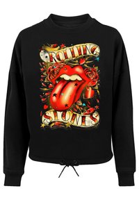 Schwarzer Sweatshirt mit einem grafischen Design, das ein rotes Zungensymbol, Rosen, Sterne und den Text "ROLLING STONES" in dekorativen Buchstaben zeigt.