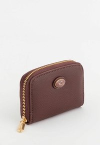 Brown leather wallet with a textured finish, rounded shape, gold zipper, and a circular logo accent on the front. Compact design.