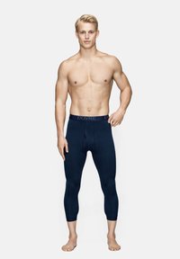 Mørkeblå leggings lavet af strækbart stof, med en elastisk talje med logo og en tætsiddende pasform, der strækker sig til midt på læggen.