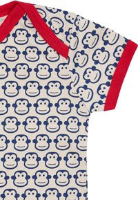 Baumwollbody mit rotem Saum, der ein ganzflächiges Muster mit blauen Affengesichtern auf cremefarbenem Hintergrund zeigt. Kurze Ärmel und eine weiche Textur.