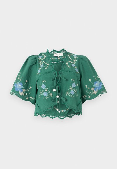 Green embroidered blouse with puffed sleeves, lace trim, front ties, and floral patterns in blue and white accents.