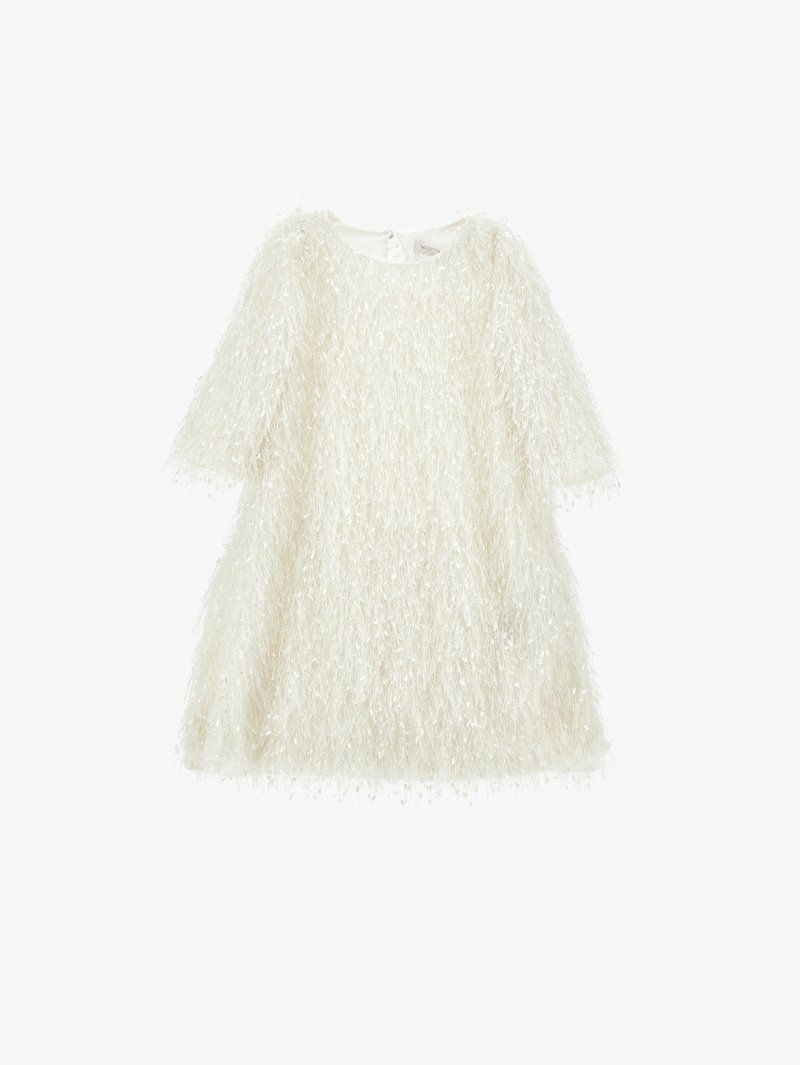 White fluffy short-sleeve top with a textured, fuzzy appearance; features a wide neckline and a hem that falls near the waist.