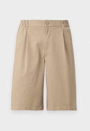 Béžové krátke nohavice do kolien so zapínaním na gombík, pútkami na opasok a elastickými stranami na jednoduchom bielom pozadí.