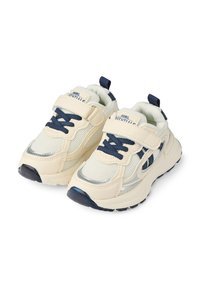 Cream-colored sneakers with navy accents, mesh and synthetic upper, adjustable strap, and laces, featuring a textured sole and reflective details.
