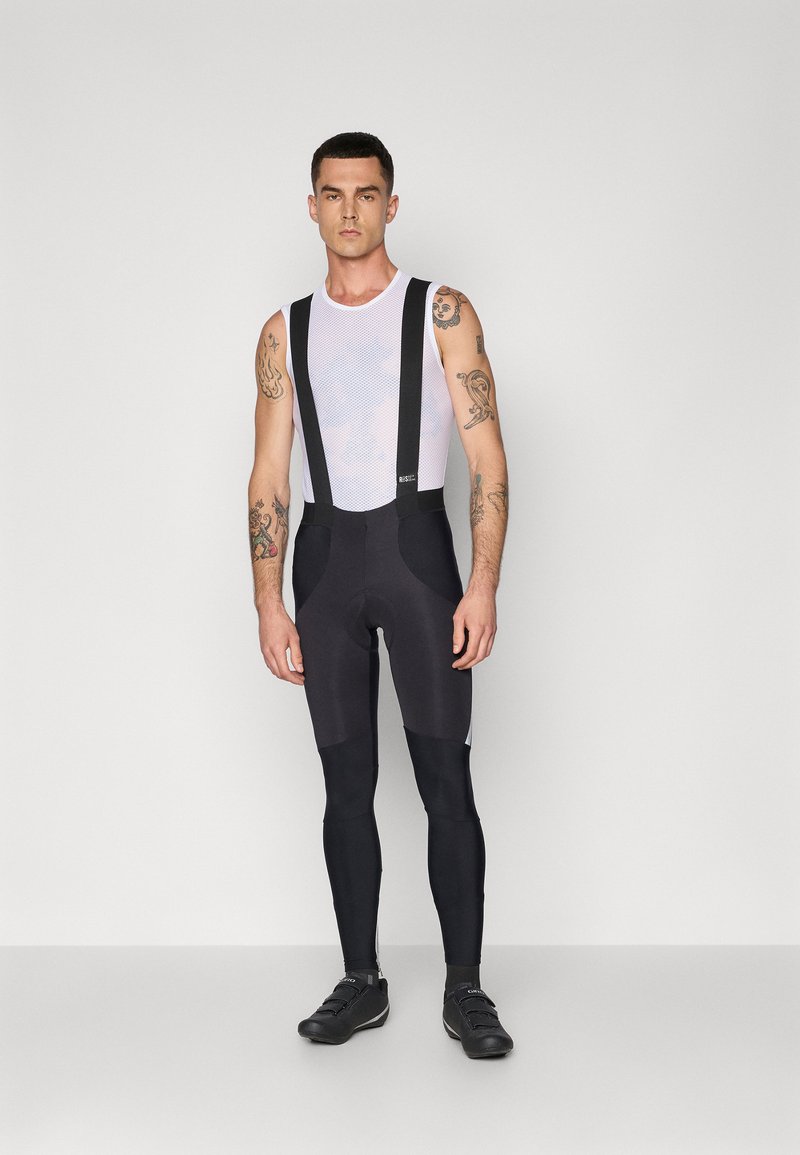 Cuissard de vélo noir avec bretelles ajustables, partie supérieure en mesh et siège rembourré. Comprend un tissu lissant et des coutures durables.