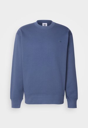 Felpa blu con scollatura rotonda, maniche lunghe, polsini a coste e un piccolo logo ricamato sul petto. Realizzata in tessuto morbido.