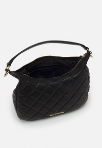 Black quilted handbag with a rounded shape, leather material, gold hardware accents, and a zip closure. Interior is lined with black fabric.