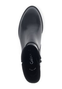 Bottine en cuir noir avec une finition lisse, bout rond, fermeture éclair et léger talon. La doublure intérieure est douce et moelleuse.