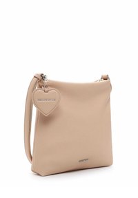 Beige leather handbag with a smooth texture, featuring a detachable heart-shaped tag and a silver zipper. Compact square design with a shoulder strap.