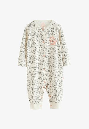 Body per neonati color beige chiaro con pois neri, maniche lunghe, bottoni frontali e polsini elastici; presenta una piccola toppa a forma di leone corallo.