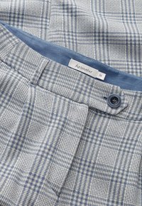 Light blue and white checkered trousers with a textured fabric, featuring a blue waistband and a button closure. Label reads "hessnatur 36."