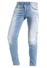 Ljust blå denimjeans med slim fit, med slitna områden och revärer vid knäna. Standard femficksdesign.