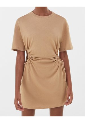 Tan short-sleeve dress with gathered side detailing, made of soft fabric. Features a round neckline and drawstring accents at the sides.