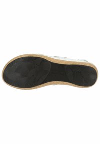 Semelle de sneaker blanche avec une surface en caoutchouc noir texturé. Présente un bord en liège léger et un motif en vagues pour une meilleure adhérence.