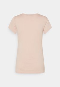 Kortärmad t-shirt med rund hals i ljusrosa bomull. Slät struktur med avslappnad passform; inga mönster eller dekorationer.