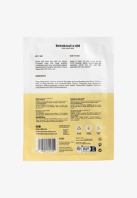 Emballage jaune vif avec texte blanc, présentant une finition brillante. Contient les détails des ingrédients et les instructions d'utilisation au dos.