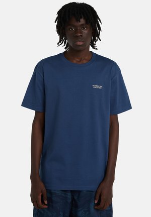 Granatowy bawełniany t-shirt z krótkimi rękawami i okrągłym dekoltem; posiada biały haftowany logo na lewej piersi. Miękka faktura.