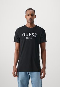 Guess - T-shirt med print - jet black Miniatyrbild 1